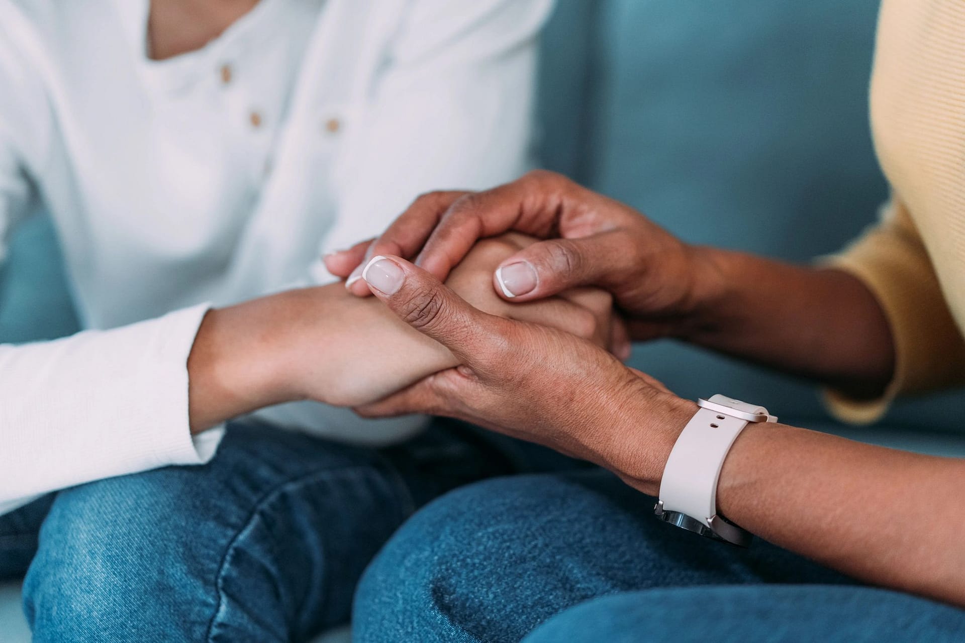 Family member holding a loved one’s hand in support